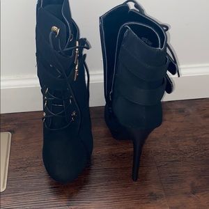 Black heeled boots .